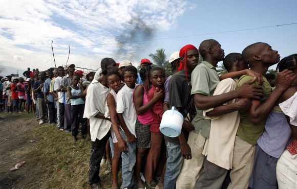Haitians in the sprawling slum of Cité Soleil queue for WFP  food distributed by a Brazilian battalion of the UN Stabilization Mission in Haiti