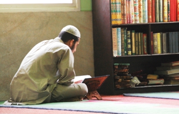 A Muslim student reciting the Qur'an in the late afternoon at the Jami Masjid in Kathmandu
