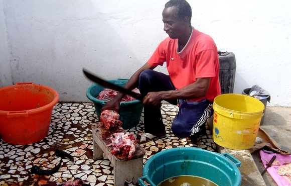 A man chops up an animal that has been slaughtered for the Muslim Eid al-Adha holiday in Dakar, Senegal in 2007. Normally, such meat is distributed to the poor, and the rest of the body thrown away, but Muslims are increasingly finding innovative ways to 