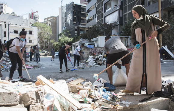 Volunteers clean up the damage in Beirut