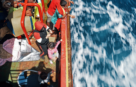 Rescued asylum seekers and migrants on board the Sea-Eye 4 as the ship waits for a port of safety. 