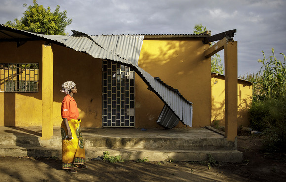 A woman looks up at a building destroyed by Cyclone Idai in 2019 in Nhamatanda, a town in Mozambique’s central Sofala province.
