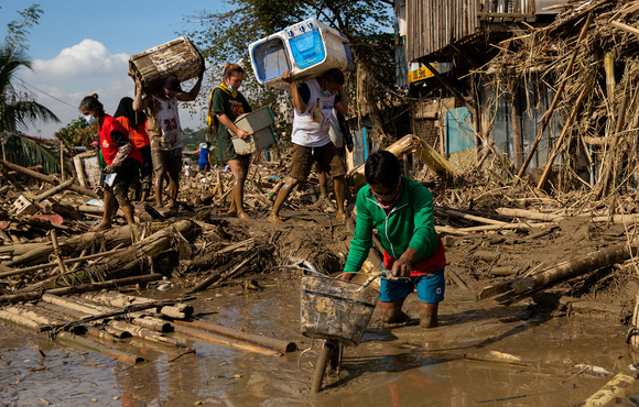 Residents retrieve belongings from their submerged homes following floods caused by Typhoon Vamco in Rizal province, east of the Philippine capital, Manila, on 14 November 2020