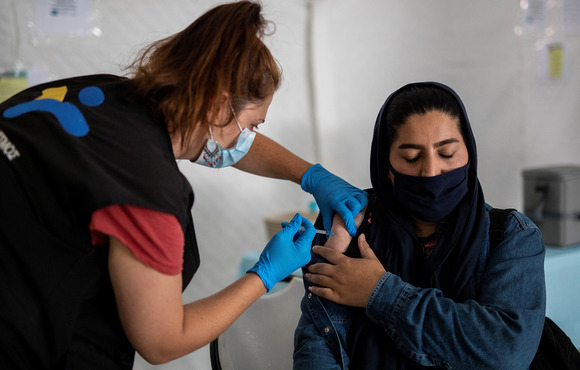 A migrant receives a shot of the Johnson & Johnson vaccine against COVID-19 in the Mavrovouni camp for refugees and migrants on the island of Lesvos, Greece, 3 June, 2021.