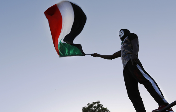 A Sudanese activist waves the national flag