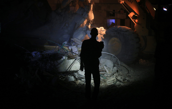 A resident inspects damage in Douma