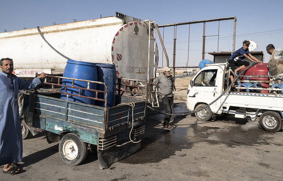Trucks carrying water from the countryside at the entrance to Hassakeh city, in northeast Syria. 