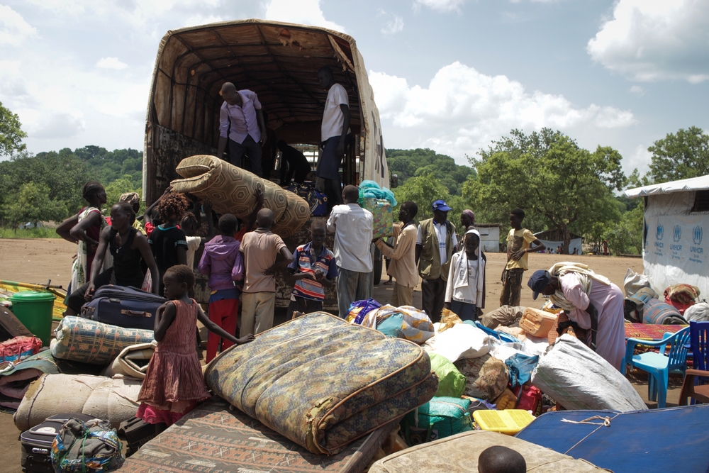 South Sudan refugees unloading at Maaji refugee settlement