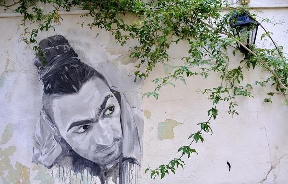 A portrait of Adam Jawad painted on the walls of the cultural centre where he worked in Amman.