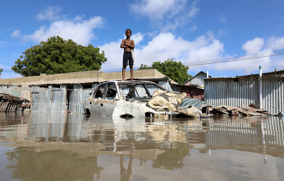 A Somali boy stands on a junk vehicle after heavy rain flooded their neighbourhood in Mogadishu, Somalia 21 October 2019.